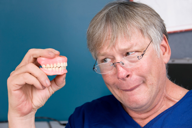 Patient looking displeased at dentures